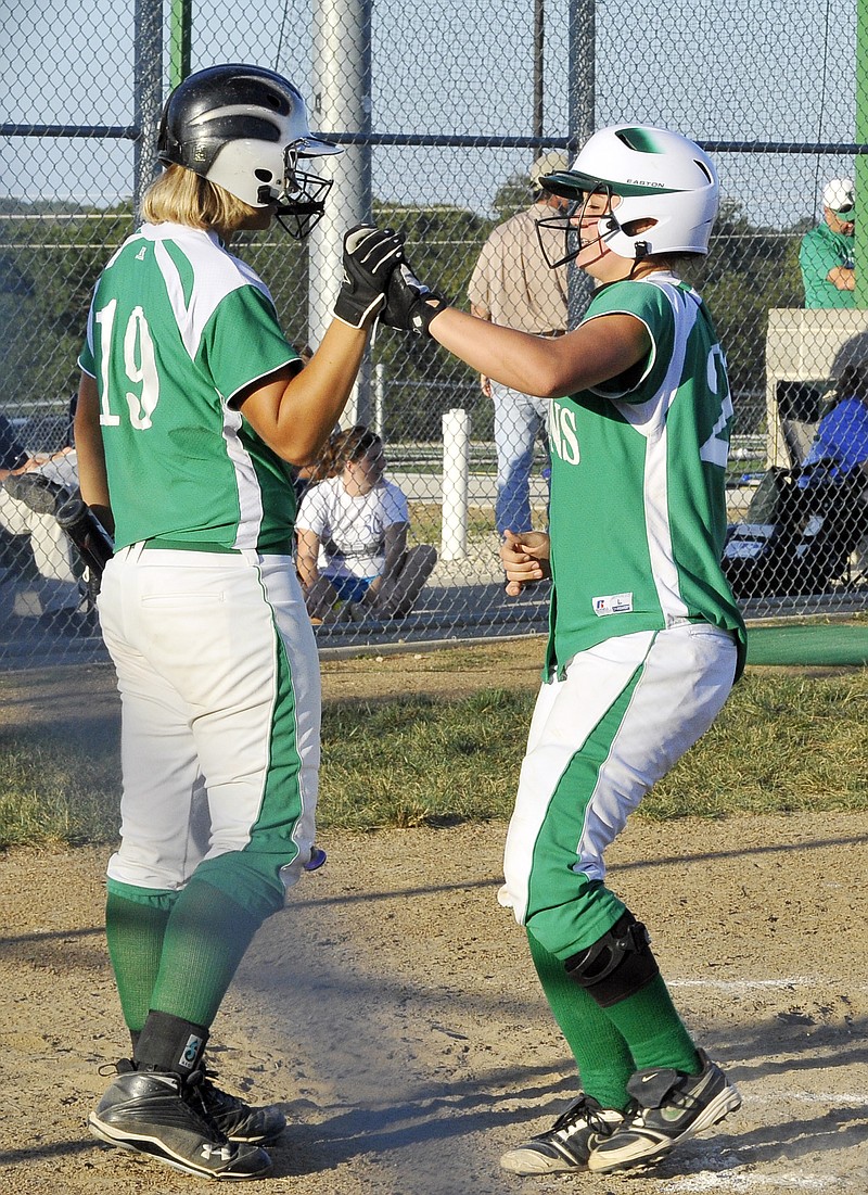 Shannon Light (right) is greeted by Blair Oaks teammate Amy Dorge after hitting a home run in the bottom of the fourth inning of Monday's game against Versailles at the Falcon Athletic Complex. Dorge had homered earlier in the game.