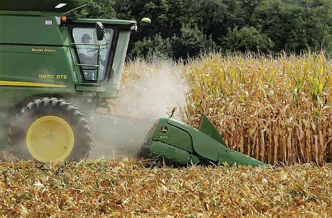 This file photo taken Aug. 30, 2011, in Central Illinois shows farmer Jason Podany using a combine to harvest corn near Farmingdale, Ill. A federal judge in Los Angeles is considering issues in a lawsuit filed by sugar industry lawyers who claim the makers of high fructose corn syrup are engaged in misleading advertising by calling the sweetener "corn sugar."