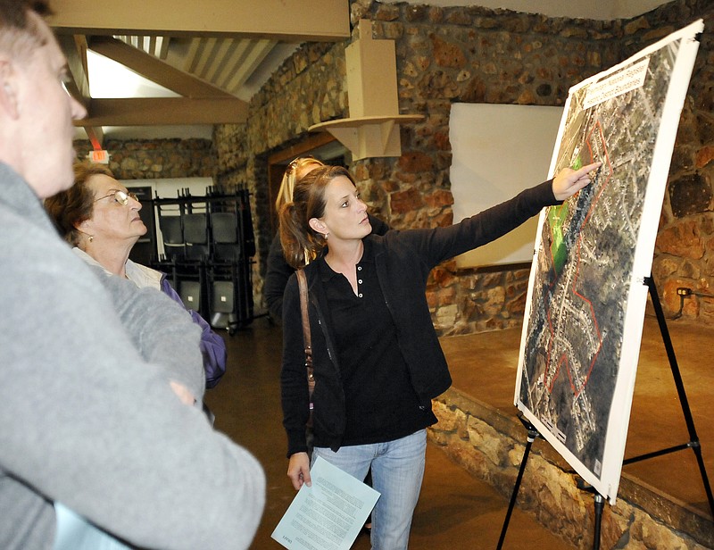 Christine Valentine points to her street on the map of the proposed boundries of the National Historic District Wednesday at the McClung Park Pavilion. She and her neighbors in the Moreau Drive area attended an informal public meeting to learn more about the intent to nominate the area to the National Register of Historic Places. 