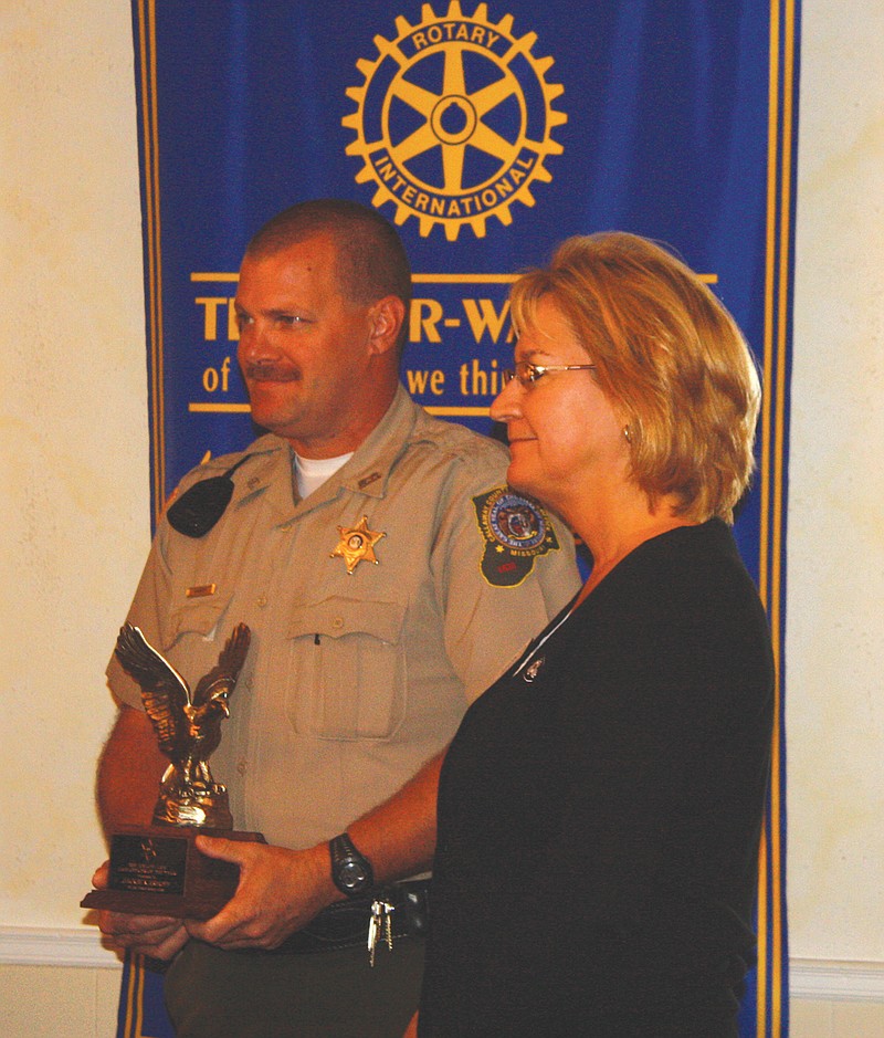 Callaway County Sheriff's Office Deputy Jackie Karhoff accepts the George W. Law Award from Marcia Lamons, Rotary Club president, Wednesday at the Fulton Country Club.