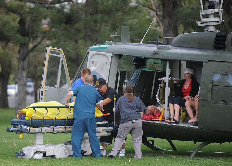Medics help injured bystanders out of a helicopter Friday at Renown Medical Center after a plane crashed into the crowd at the Reno National Championship Air Races in Reno, Nev. A World War II-era fighter plane plunged into the grandstands during a popular annual air show, injuring scores of spectators and leaving a horrific scene of bodies and wreckage.