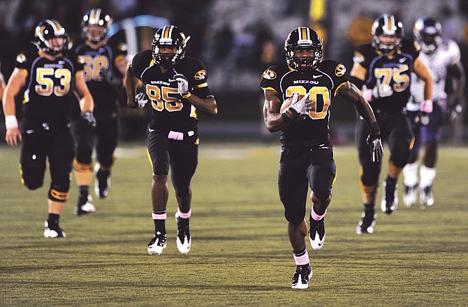 Missouri running back Henry Josey leads a brigade of Tigers down the field on a 68-yard touchdown run during the second quarter of Saturday night's game against Western Illinois at Faurot Field.