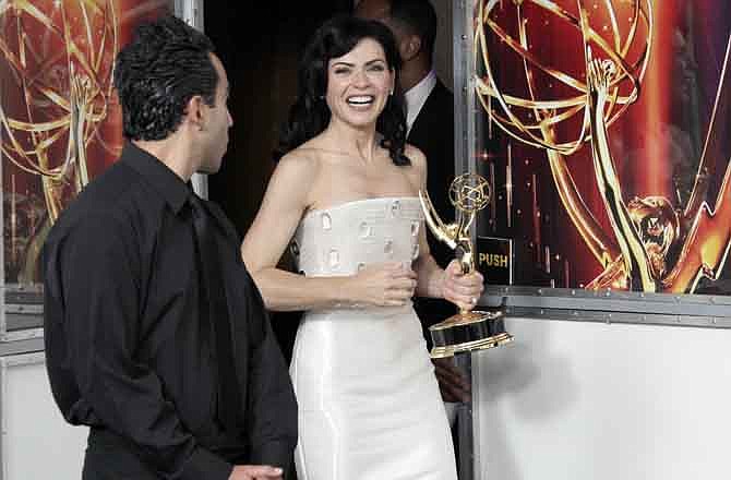 "The Good Wife" cast member Julianna Margulies poses with the Emmy for best lead actress in a drama series backstage at the 63rd Primetime Emmy Awards on Sunday, Sept. 18, 2011 in Los Angeles.