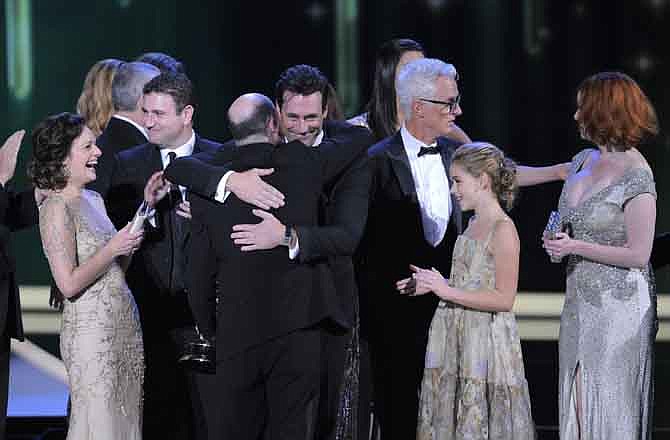 Cast and crew of Mad Men and creator Matthew Weiner, center, accept the award for outstanding drama series at the 63rd Primetime Emmy Awards on Sunday, Sept. 18, 2011 in Los Angeles.