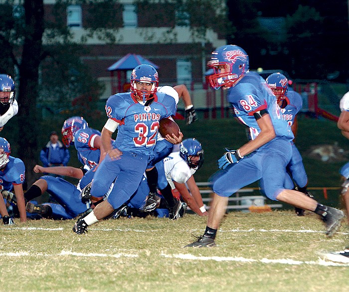 California's Christopher Allee (32) gains 27 yards during first quarter action at the Pintos' varsity football game against Montgomery County Friday night at Riley Field.