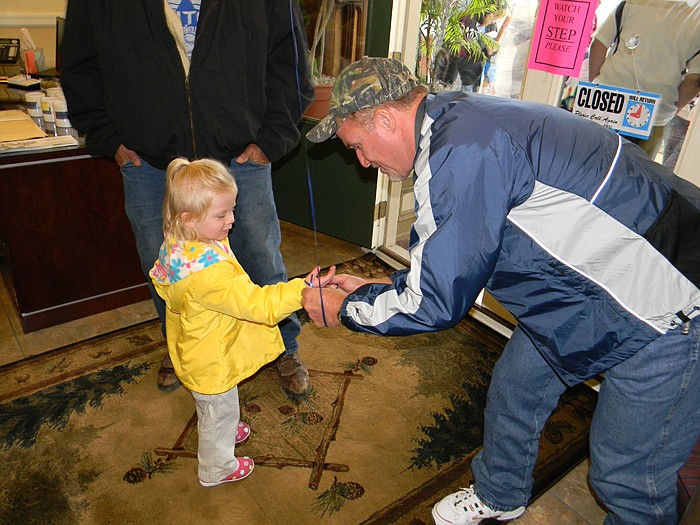 David Sumter hands Emma Batye a balloon at the Commonsense Coalition Talk Radio Open House.