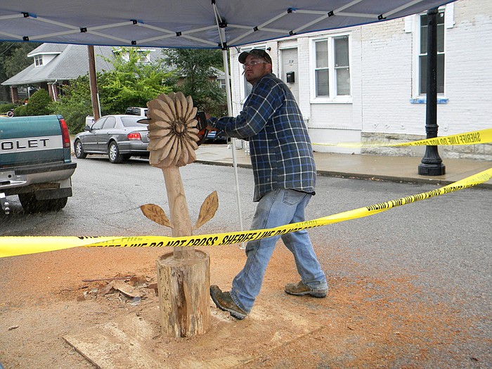 Curt Drinkard carves this flower out of a chunk of wood at the 2011 Ozark Ham and Turkey Festival where he gave chainsaw art demonstrations throughout the day.