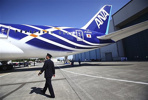 In this Aug. 6, 2011 file photo, All Nippon Airways (ANA) pilot Yoshio Taneda does a walk-around during the reveal of the first Boeing 787 destined for use by launch customer ANA at the Boeing plant in Everett, Wash. Boeing will deliver its first 787 jet Sunday, Sept. 25, 2011, to Japan's All Nippon Airways. 