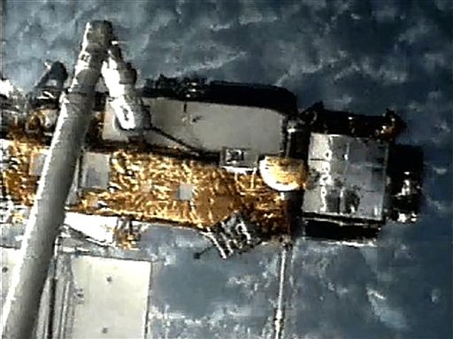 This screen grab image provided by NASA shows UARS attached to the robotic arm of the space shuttle Discovery during mission STS-48 in 1991, when UARS was deployed. The failing satellite fell to Earth on Saturday, but the exact location was not immediately known.