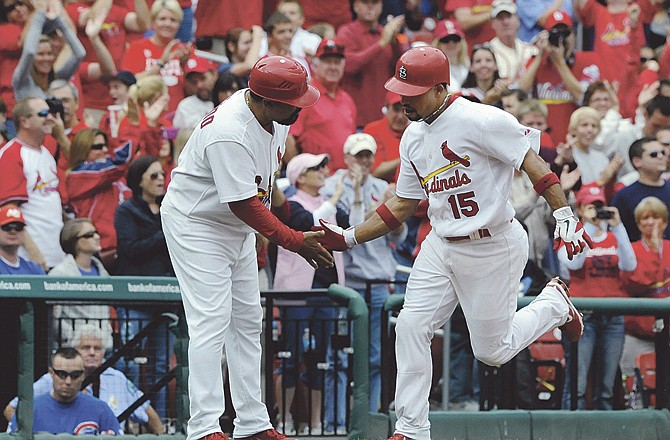 St. Louis Cardinals' Rafael Furcal (15) is congratulated by third base coach Jose Oquendo, left, after his solo home run against the Chicago Cubs in the eighth inning in Sunday's game in St. Louis. 
