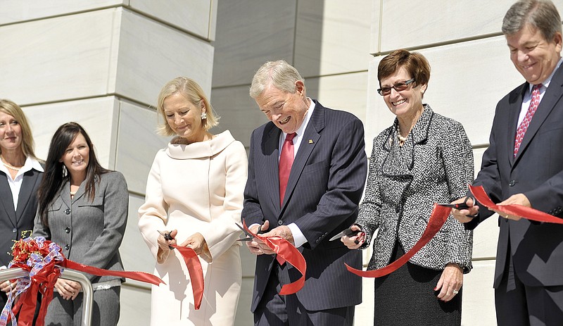 Former U.S. Sen. Kit Bond, center, joins several dignitaries cutting the ribbon Tuesday during the dedication of the Christopher S. Bond United States Courthouse. Bond was joined by his wife, Linda Bond, (center left), United States District Court Judge Nanette Laughrey and U.S. Sen. Roy Blunt is at right.