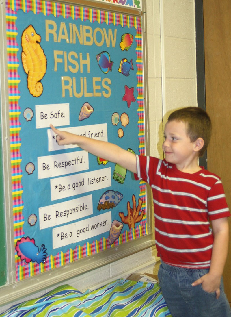 Kindergartner Bobby Olson, 5, points to his classroom's rules Friday. The rules are part of the new Positive Behavior Interventions and Supports approach Auxvasse Elementary has implemented. Olson was recognized as the "Tiger of the Week" Friday for his good behavior in class.