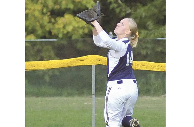 Helias' Liz Czarnecki tracks down a fly ball during Monday's game at Duensing Field.