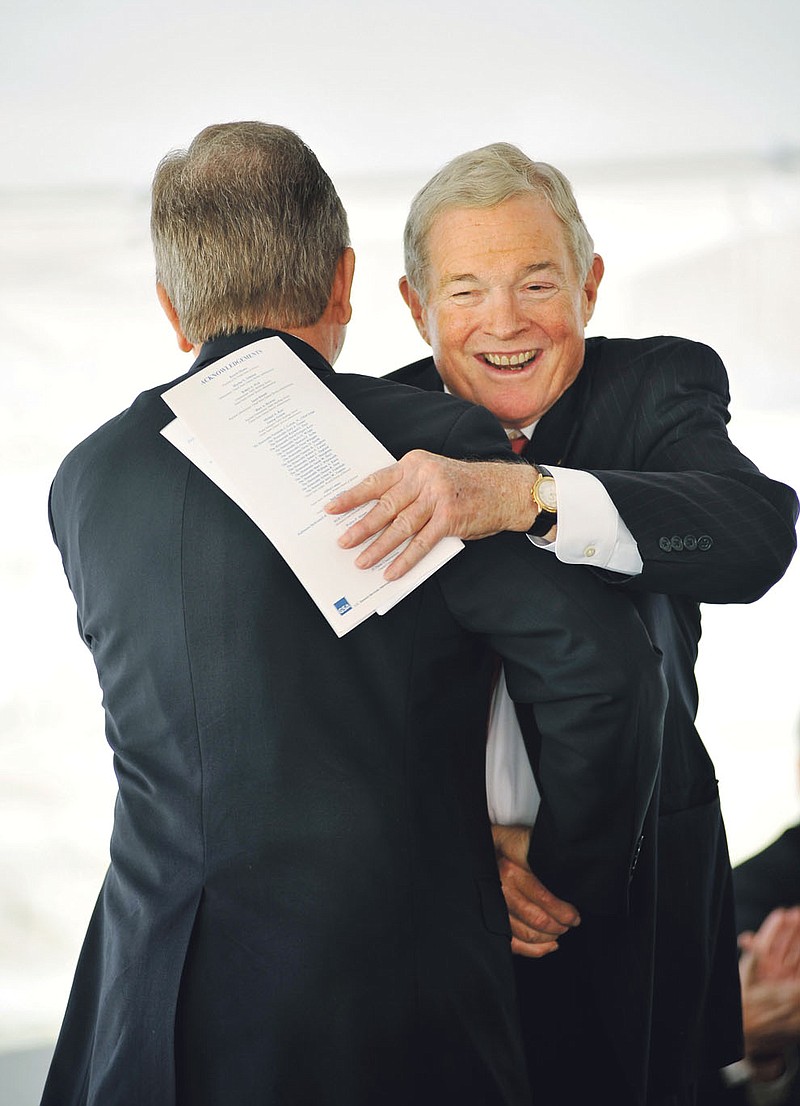 Former U.S. Sen. Kit Bond, R-Mo., right, hugs U.S. Sen. Roy Blunt as Blunt gets up to speak at the dedication of the Chritopher S. Bond United States Courthouse Tuesday, in Jefferson City. Blunt sponsored the legislation naming the building in Bond's honor, which made it through Congress just last week. President Obama signed the measure on Friday.