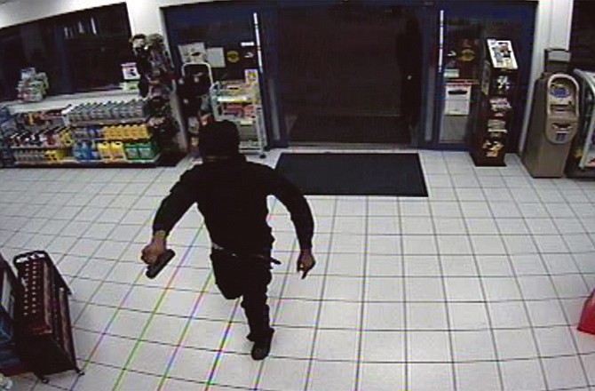 Shown is footage from a security camera during an armed robbery early Wednesday morning at the Break Time Convenience Store on Ellis Boulevard.