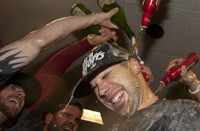 Chris Carpenter is drenched as he and his Cardinal teammates celebrate clinching the N.L. wild card Wednesday night in Houston.