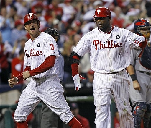 Philadelphia Phillies Ryan Howard, right, annd Hunter Pence react after Howard's three-run homer in the sixth inning of Game 1 of baseball's National League division series against the St. Louis Cardinals, Saturday, Oct. 1, 2011, in Philadelphia. 