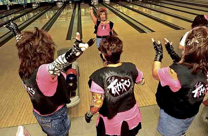 Mary McCormick, center, gets a round of cheers from her teammates after notching a spare during the second annual Bowling For Boobies fundraiser at West Gate Lanes in Jefferson City.