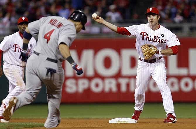 St. Louis Cardinals' Yadier Molina (4) is out as Philadelphia Phillies second baseman Chase Utley (26) makes the throw to complete the double play to end the seventh inning of baseball's Game 2 of the National League division series Sunday, Oct. 2, 2011 in Philadelphia.