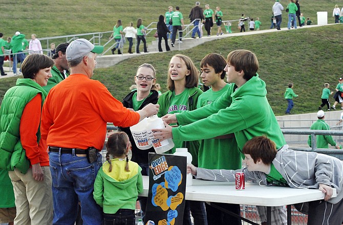 Blair Oaks Middle School students Christina Kempker, Morgan Spicer, Luke Dyer, Kyle Schulte and Theo Brown solicit donations for Over the Edge, a collection for Special Olympics, during a recent football game.