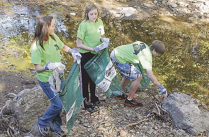 Andrea Cash, Ann Shamet and John Bexten, all students from Lewis & Clark Middle School, had a blast cleaning up the banks of Wears Creek on Saturday during the first Wears Creek Community Cleanup. 