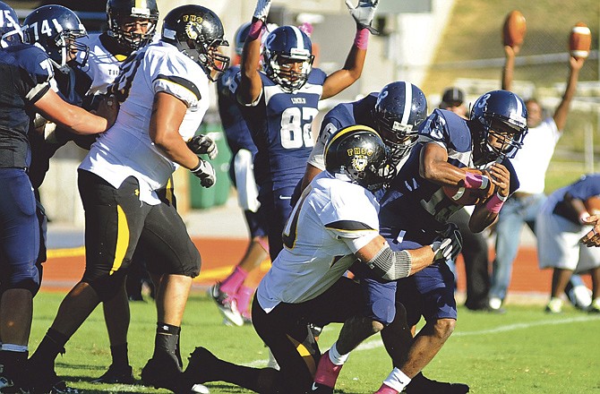 
Lincoln University redshirt freshman quarterback Robert Redmond (#13) powers his way into the end zone in the fourth quarter of Saturday's homecoming matchup with Fort Hays State at Dwight T. Reed Stadium. LU lost the contest 24-21.