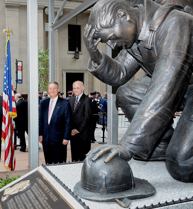 Participating in the Sept. 22 dedication of The Kneeling Fireman statue in front of the Emigrant Savings Bank in New York City are, from left, Howard Milstein, president of Emigrant Savings Bank, and New York Fire Department Commissioner Nicholas Scoppetta. It is the original statue created for the Firefighters Memorial in Kingdom City but it was donated to the Federal Law Enforcement Foundation with the approval of the Missouri Firefighters Association. A duplicate statue was created for the Firefighters Memorial in Kingdom City.  