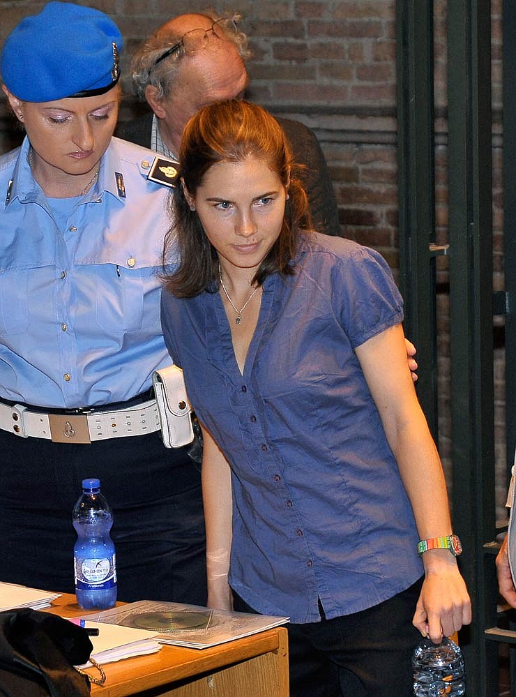 Amanda Knox, right, is escorted by a police officer as she arrives for an hearing of her appeals case at the Perugia court, Italy, Monday, Sept. 5, 2011. The appeals case of Amanda Knox, the American student convicted of killing her British roommate, resumed Monday with lawyers questioning independent experts who cast doubt on the evidence used in the first trial. The 24-year-old from Seattle who has been behind bars since the November 2007 murder was in the Perugia courtroom, as was her co-defendant and onetime boyfriend, Raffaele Sollecito. Ahead of the hearing, the first after the summer break, the sister of victim Meredith Kercher issued a letter asking the appeals court to assess "every single (piece) of evidence" so that justice can be done.