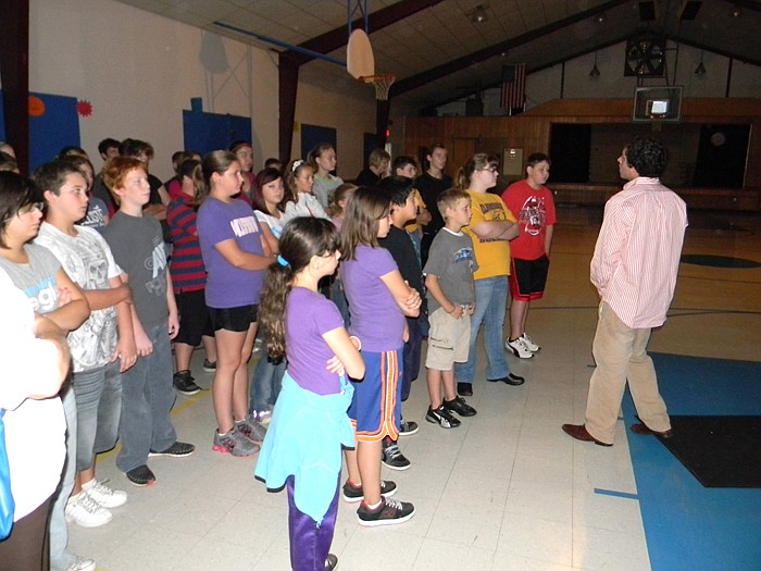 Kyle Buist from Kramer Entertainment talks to Clarksburg sixth and seventh grade students Thursday, Sept. 29, before letting them inside the Dome Theater to see "Night of the Titanic."