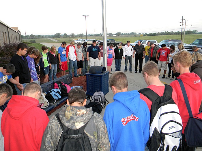 Students along with teachers and other adults join hands at California High School and prepare to pray during the "See You At The Pole" rally held Wednesday, Sept. 28.