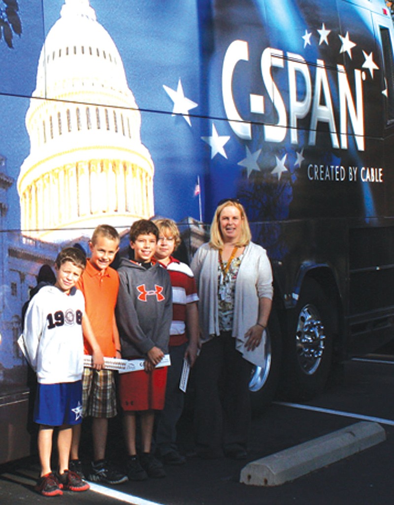 Fulton Middle School students with their social studies teacher Heather Yates after they and 51 other 6th graders toured the C-SPAN Campaign 2012 bus that stopped at Westminster College Wednesday. Students from left are: Nathan Quick, Gabe Luebbert, Lucas Desmit and Jonah Preston.