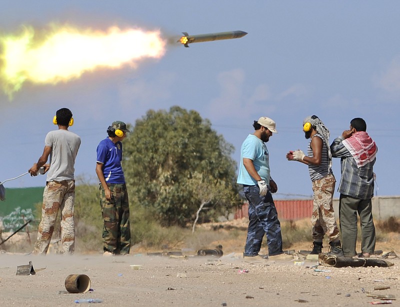 Libyan revolutionary fighters fire a missile during an attack Wednesday for the city of Sirte, Libya. Rebels use tanks and heavy artillery toward loyalist positions inside the hometown of Libya's ousted leader Moammar Gadhafi.