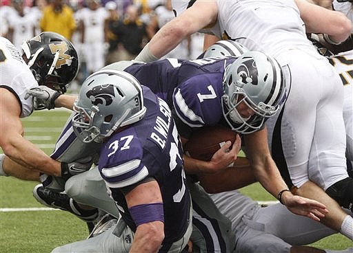 Kansas State quarterback Collin Klein (7) scores a touchdown against Missouri in the third quarter of an NCAA college football game in Manhattan, Kan., Saturday, Oct. 8, 2011. 