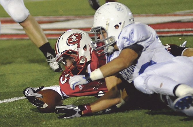 Jefferson City's Jack Young recovers a muffed punt during Friday's game with Rockhurst at Adkins Stadium.