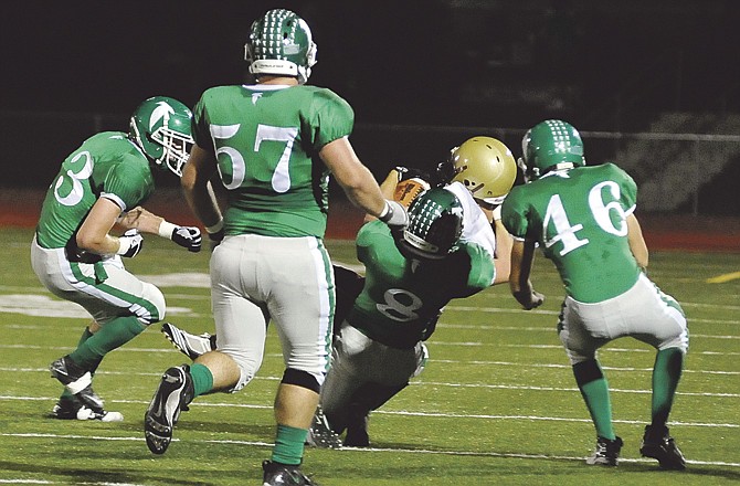 Blair Oaks' Tanner Kemna (8) brings down an Eldon player Friday night at the Falcon Athletic Complex as teammates Ben Cooper (13), Brad Richter (57) and Eli Roberts (46) close in.