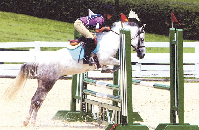 Kate Pani, 11, competes in the show jumping part of the tetrathlon event on Fancy That during the United States Pony Club National Championships held in Lexington, Ky.