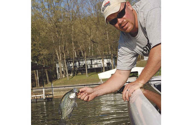 Mark Wasson of Harrisburg holds a fish he caught at the Lake of the Ozarks. 