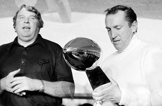 In this Jan. 9, 1977, file photo, Oakland Raiders coach John Madden, left, talks as team owner Al Davis holds the Vince Lombardi Trophy after the Raiders' 32-14 victory over the Minnesota Vikings in Super Bowl XI in Pasadena, Calif. Davis, the Hall of Fame owner of the Raiders known for his rebellious spirit, has died, the team announced on Saturday, Oct. 8, 2011.