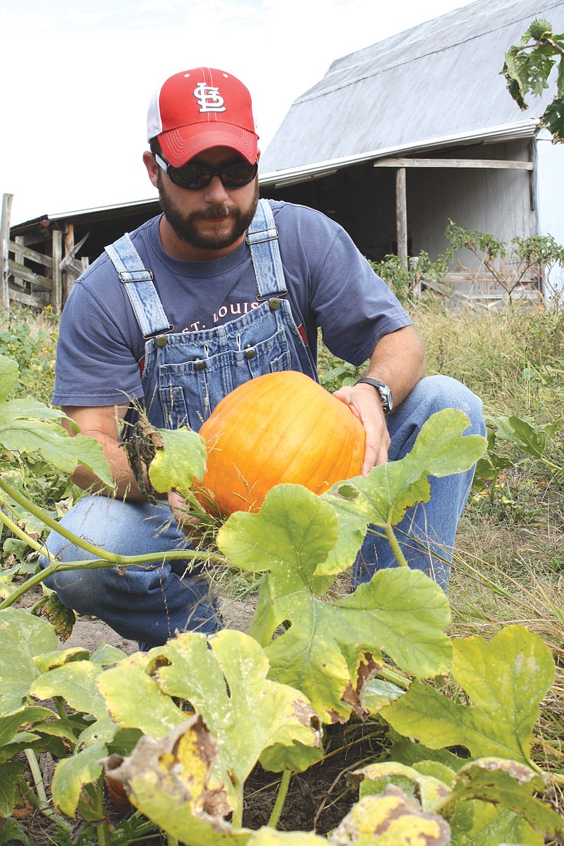 Landry Jones holds a pumpkin Monday that he grew for the Fulton Breakfast Optimist Club's fundraiser. 