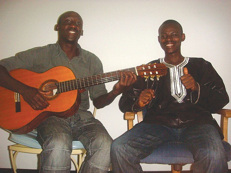 (Left) Valens Hasubizmana and Felix Ndashimye visit with friends in the Fulton area shortly after their arrival to the U.S.