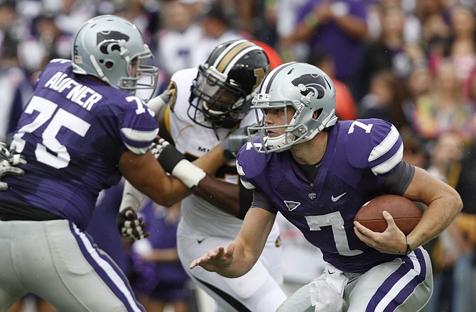 Kansas State quarterback Collin Klein picks his way through the Missouri defense during Saturday's game in Manhattan, Kan. After their 24-17 loss to the Wildcats, the Tigers are shaking up their lineup.