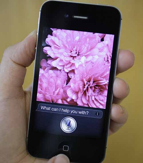 In this photo taken Monday Oct. 10, 2011, Siri, the new virtual assistant, is displayed on the new Apple iPhone 4S in San Francisco. The 4S will be available Friday in black or white. It will cost $199-$399, depending on included storage space, with a two-year service contract with Verizon Wireless, Sprint or AT&T.