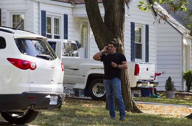 Bill Stanton, private investigator, talks on a cellphone in the front lawn of a Northland home where the parents of 11 month-old Lisa Irwin were staying on Wednesday, Oct 12, 2011, in Kansas City, Mo. Stanton, a New York-based security consultant who said he was hired by a wealthy benefactor to help search for a missing baby in Kansas City got little response Wednesday from police who have been looking for the child for more than a week. (AP Photo/The Kansas City Star, Shane Keyser)