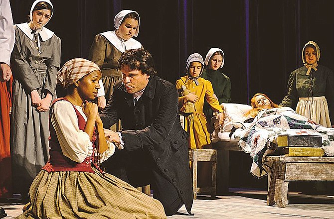 The Rev. John Hale (Tom Baker) questions Tituba (Danielle Thomas) as cast members from The Little Theatre of Jefferson City run through a dress rehearsal of "The Crucible." The Little Theatre production of the Arthur Miller drama runs today through Saturday at the Miller Performing Arts Center.