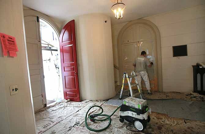 In this Sept. 22, 2011 photo, painter Tom Godlewski applies primer on a door inside the foyer of Christ Church in Cambridge, Mass., during renovation work on the historic 18th century Anglican church. A ceremony is soon planned to celebrate the church's 250th anniversary. 