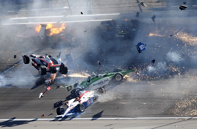 Drivers crash during a wreck that involved 15 cars during the IndyCar Series' Las Vegas Indy 300 at Las Vegas Motor Speedway. Indy 500 winner Dan Wheldon died following the crash.
