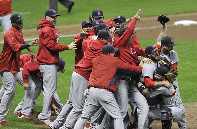 The St. Louis Cardinals celebrate after Game 6 of the National League championship series against the Milwaukee Brewers. The Cardinals won 12-6 to win the series and advance to the World Series.