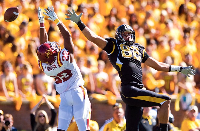 Missouri tight end Michael Egnew and Iowa State defensive back Ter'Ran Benton reach for a pass during Saturday afternoon's game at Faurot Field.
