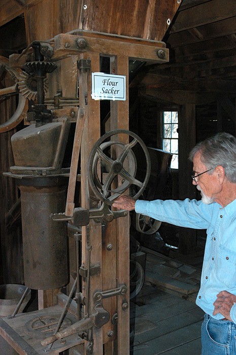 Jim Martin explains the flour sacker at the 1869 Dick's Mill at the open house on Saturday, Oct. 15.