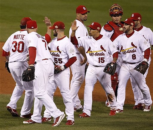 Members of the St. Louis Cardinals celebrate Wednesday following their 3-2 victory against Texas in Game 1 of the World Series at Busch Stadium.